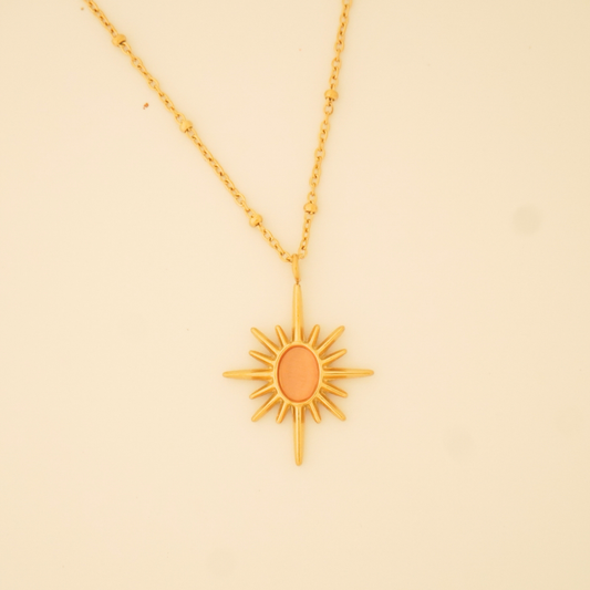 18K gold-plated sunburst pendant necklace with minimalist orange enamel center on a delicate chain from Ashara Jewels