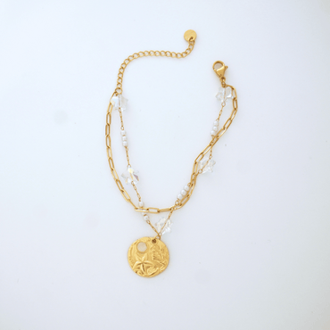 Gold bracelet with a pendant on a white background