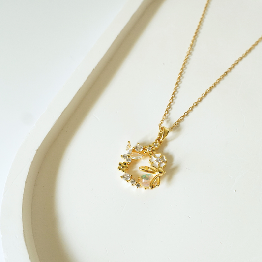 Floral 18k gold-plated dragonfly pendant necklace by Ashara Jewels placed on a neutral background”