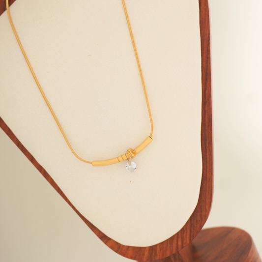 Minimal gold necklace with knot detail and silver charm – Ashara Serene Knot Necklace