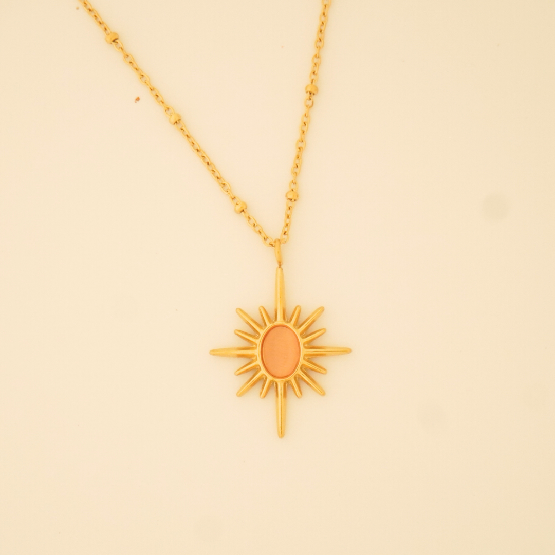 18K gold-plated sunburst pendant necklace with minimalist orange enamel center on a delicate chain from Ashara Jewels
