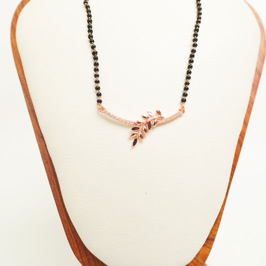Rose gold anti-tarnish mangalsutra with leaf design and CZ stones on a black bead chain
