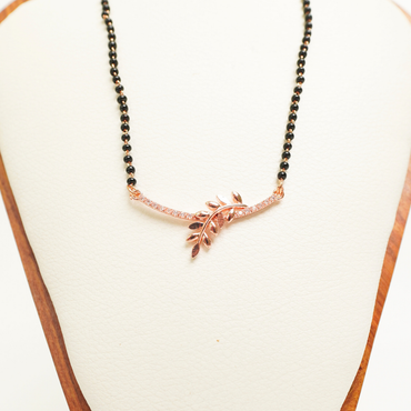 Rose gold anti-tarnish mangalsutra with leaf design and CZ stones on a black bead chain
