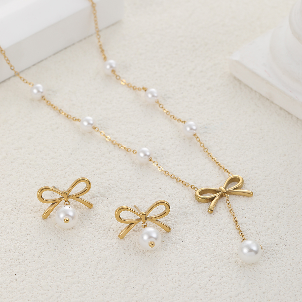 Gold bow and pearl necklace with matching earrings – Ashara Jewels”
