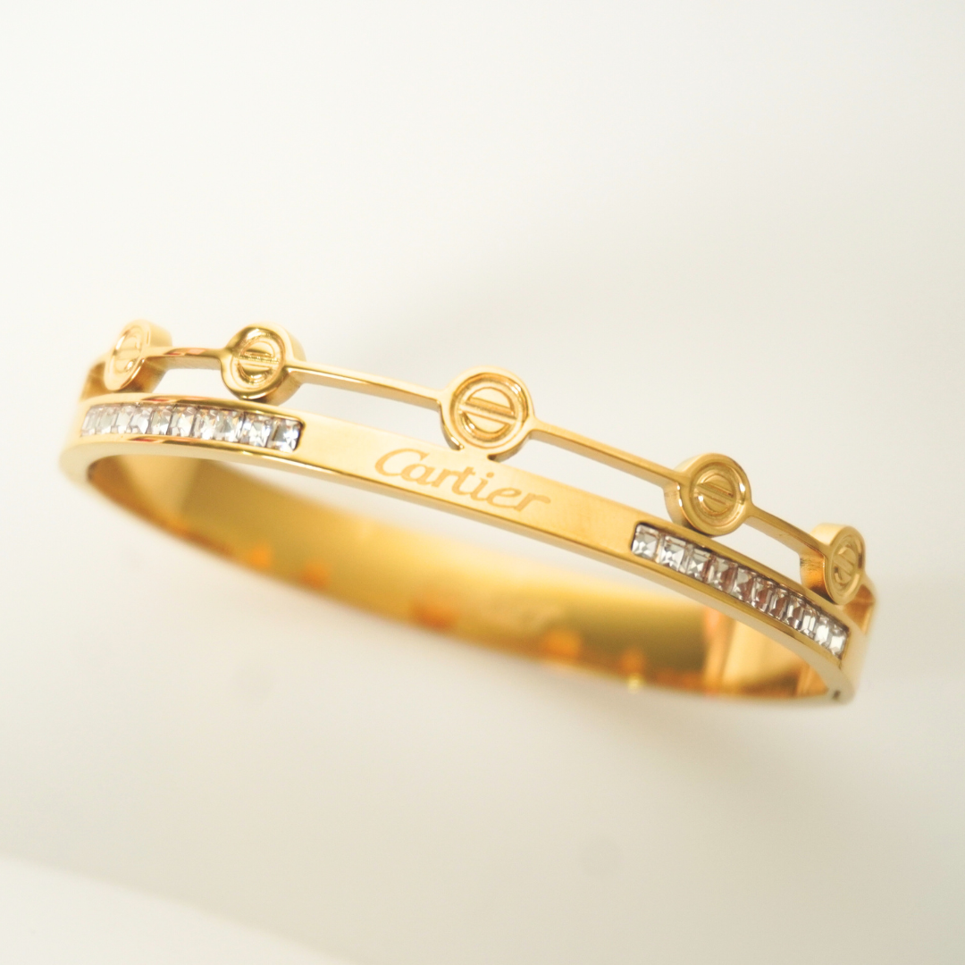 Gold Cartier-inspired dual band bracelet with illusion-cut stones and circular detailing – Ashara Jewels”